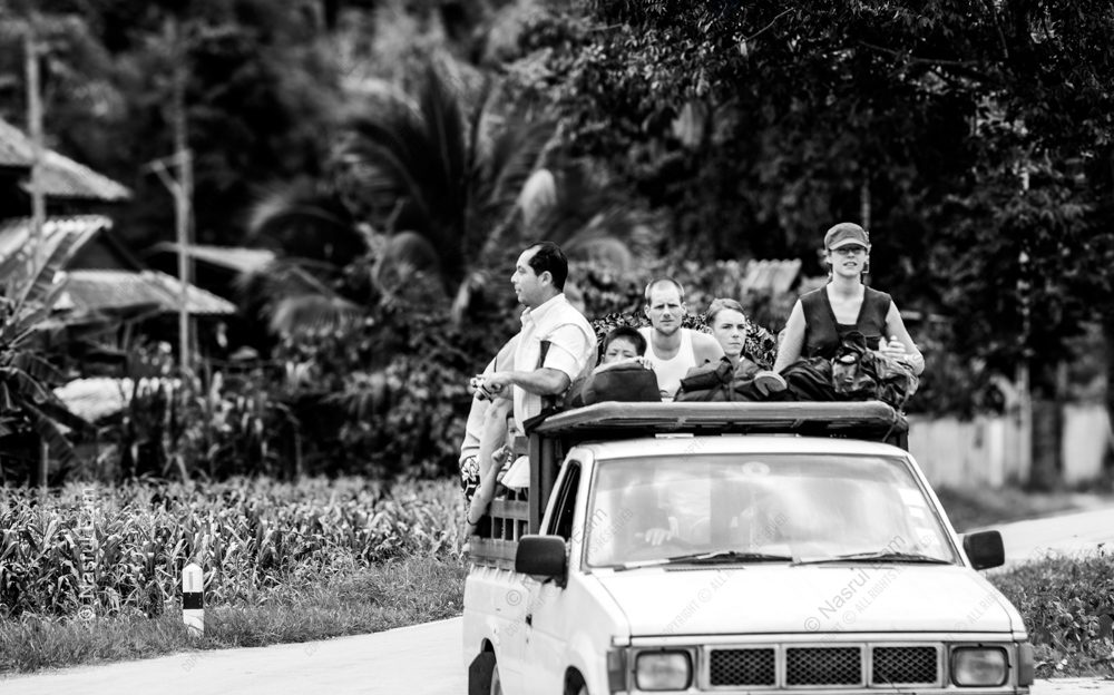Travelers on a Road Through the Village