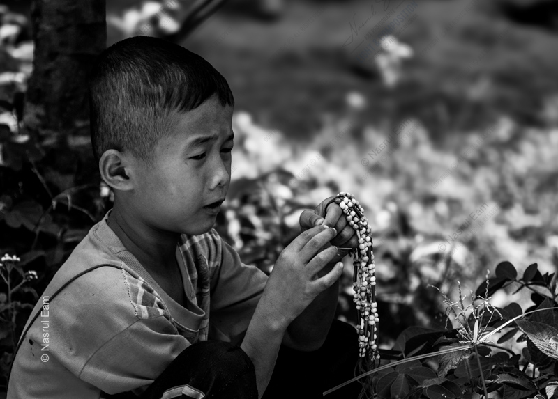 A Young Boy with a String of Beads