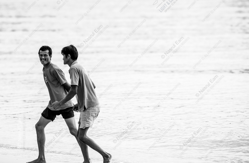 Two Men Walking by the Sea