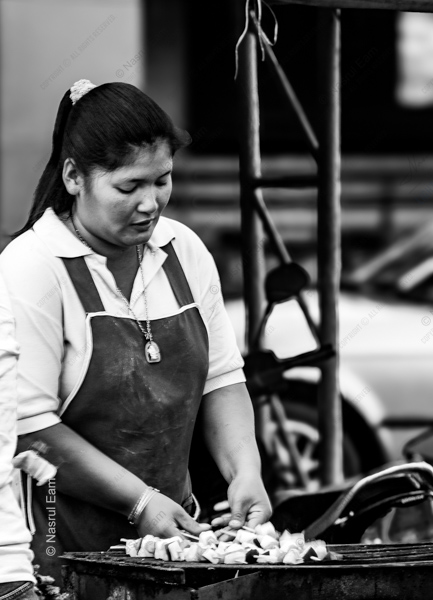 A Woman Preparing Skewers