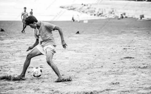 Barefoot Focus: A Boy's Game on the Sands