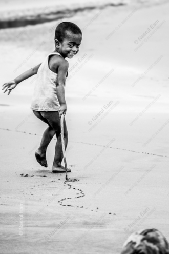 Boy Drawing on the Beach