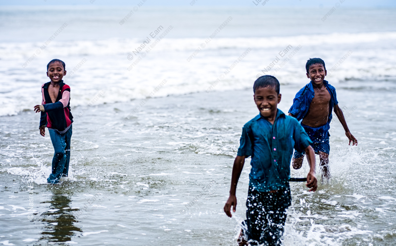 Three Boys in the Ocean Surf