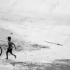 A Boy Running with a Tire Hoop - Fine Art Photography Print, Limited Edition Photography, Giclée Print, Black and White Photography, Art Photography Investment