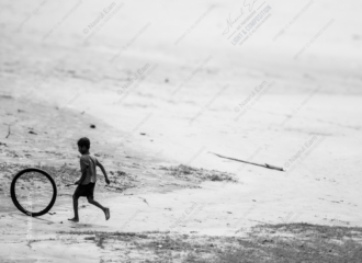 A Boy Running with a Tire Hoop - Fine Art Photography Print, Limited Edition Photography, Giclée Print, Black and White Photography, Art Photography Investment