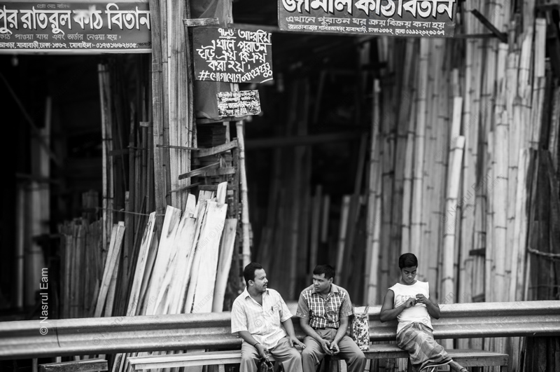 Men Seated Before a Wall of Bamboo