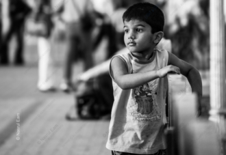 Boy at the Edge of the Crowd