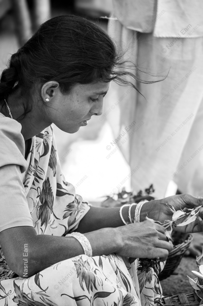 Woman Tending to Leaves in the Wind