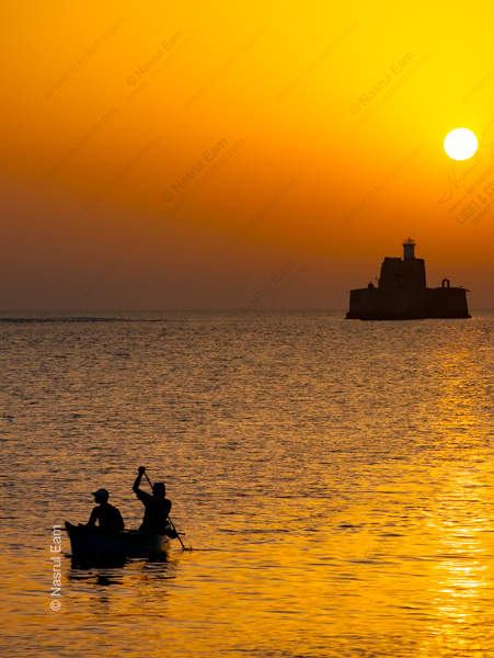 Two Paddlers Before the Sea Fort at Sunset