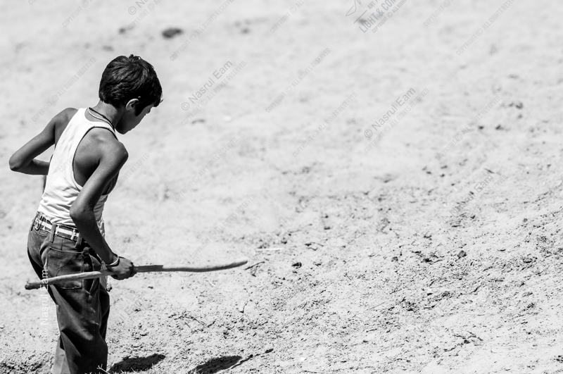 Boy with a Stick in the Dust