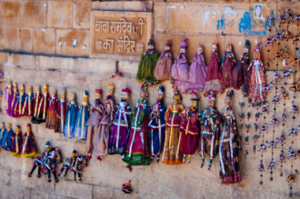 A Chorus of Puppets on a Sandstone Wall