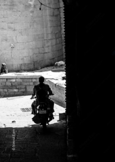 Motorcycle Rider in a Stone Passageway