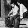 Two Boys Resting on a Timber Beam