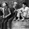 Men Seated Along the Brick Wall