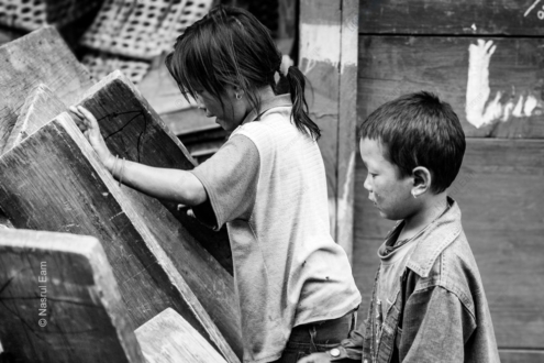 Two Children Beside Wooden Planks