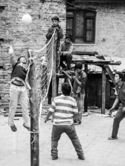 Boys' Volleyball Game by the Stone House