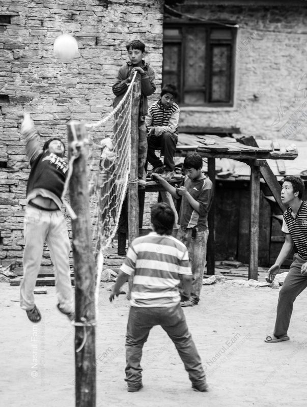 Boys' Volleyball Game by the Stone House
