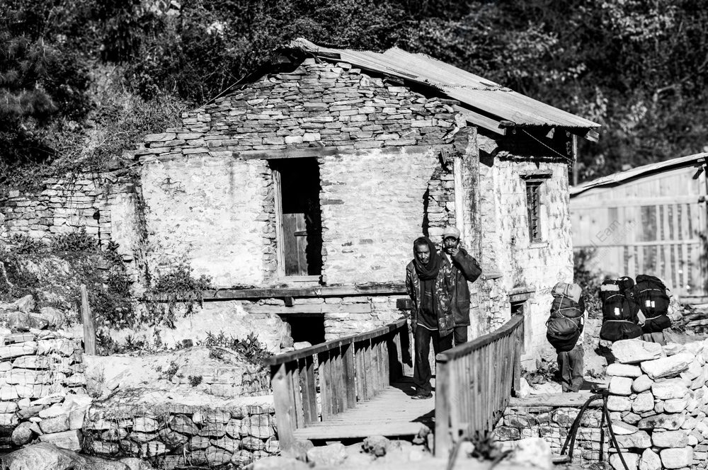 Travelers by the Stone House Bridge