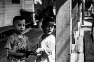 Two Boys with a Toy Rifle - Fine Art Photography Print, Limited Edition Photography, Black and White Photography,  Giclée Print,  Contemporary Art Photography