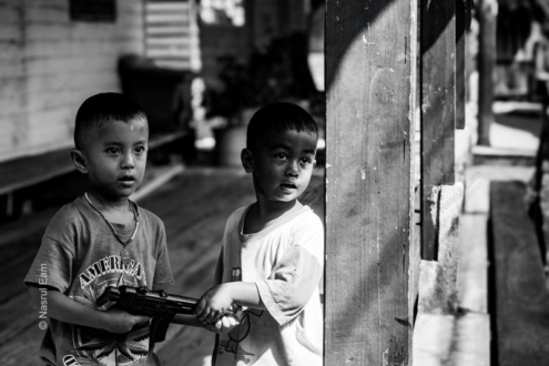Two Boys with a Toy Rifle - Fine Art Photography Print, Limited Edition Photography, Black and White Photography,  Giclée Print,  Contemporary Art Photography