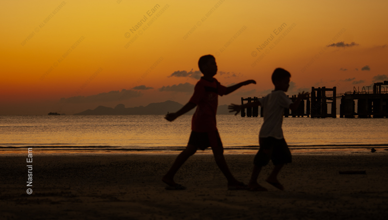 Two Boys on the Shore at Dusk