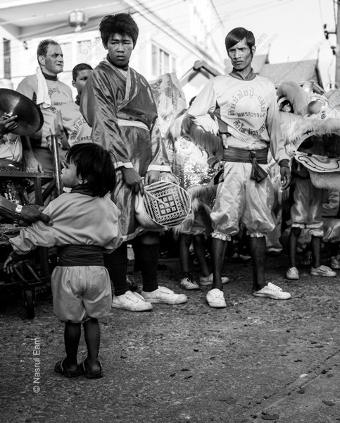 Festival Performers and a Child in the Street