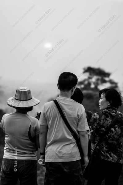Three Figures Facing the Hazy Sun