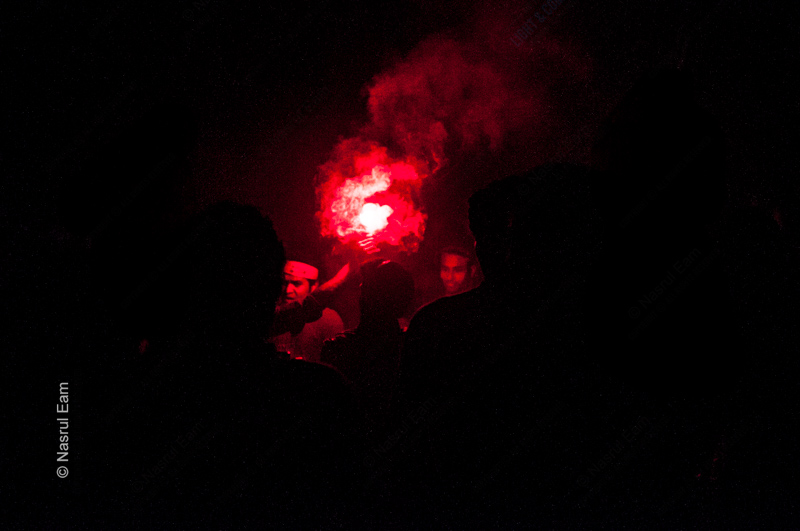 A Red Flare Held Aloft in the Darkness