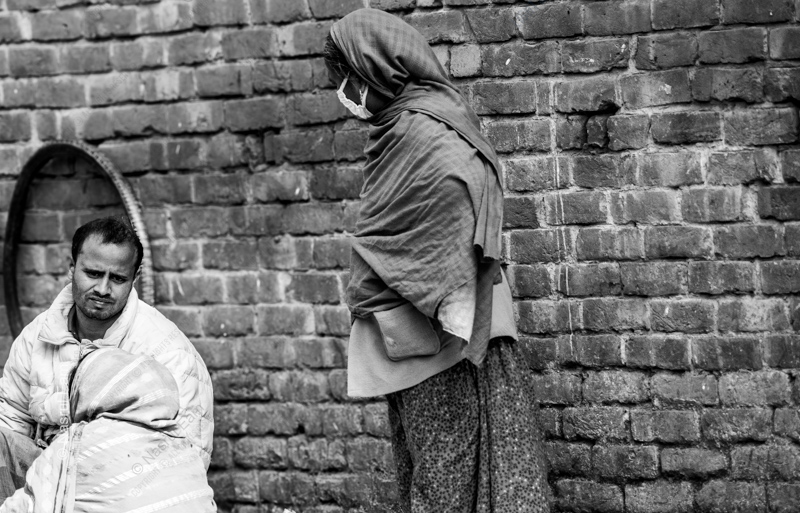 Three Figures by the Brick Wall