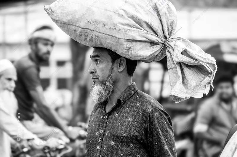 A Man Carrying a Large Sack