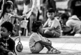 A Girl in Thought, Beside a Toy Scooter