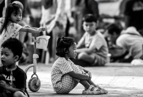 A Girl in Thought, Beside a Toy Scooter