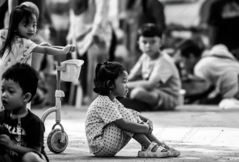 A Girl in Thought, Beside a Toy Scooter
