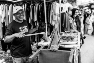 The Laughing Man at the Market Stall - Fine Art Photography Print, Limited Edition Photography, Black and White Photography, Documentary Photography, Art Photography for Sale