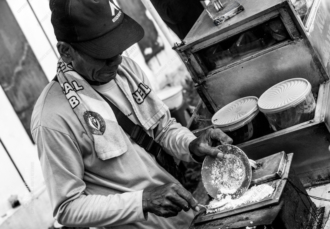Vendor's Hands at the Griddle