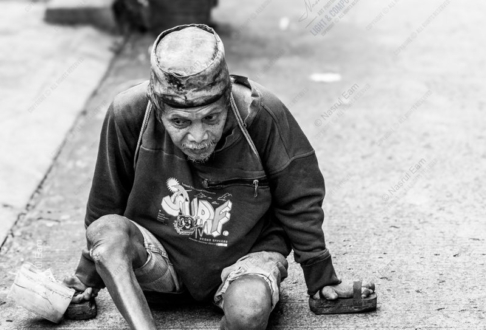 Man with Wooden Blocks on the Pavement
