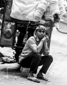 Street Vendor Resting Beside His Cart