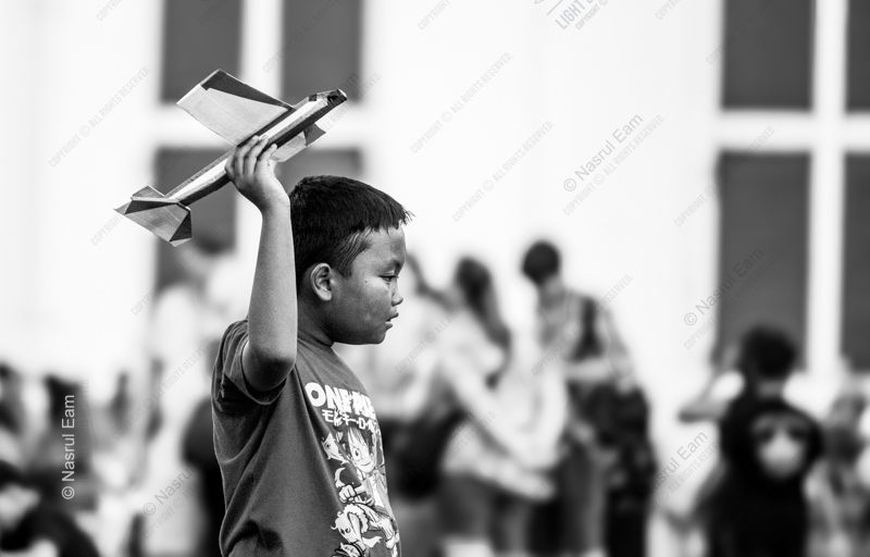 A Boy Lifting His Airplane