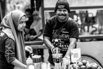 The Juice Vendor's Welcoming Gaze - Fine Art Photography Print, Limited Edition Photography, Street Portraiture, Black and White Photography, Documentary Photography