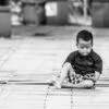 A Boy and His Phone on a Wooden Floor