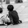 Two Boys on a Wooden Walkway