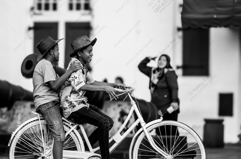 Two Boys on a White Bicycle
