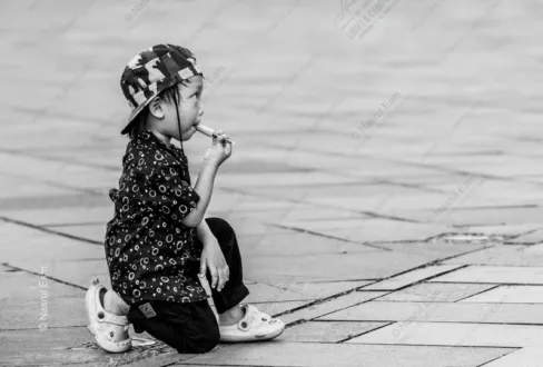 Child with an Ice Pop on the Pavement - Fine Art Photography Print, Limited Edition Photography, Black and White Photography, Documentary Photography,  Child Portrait