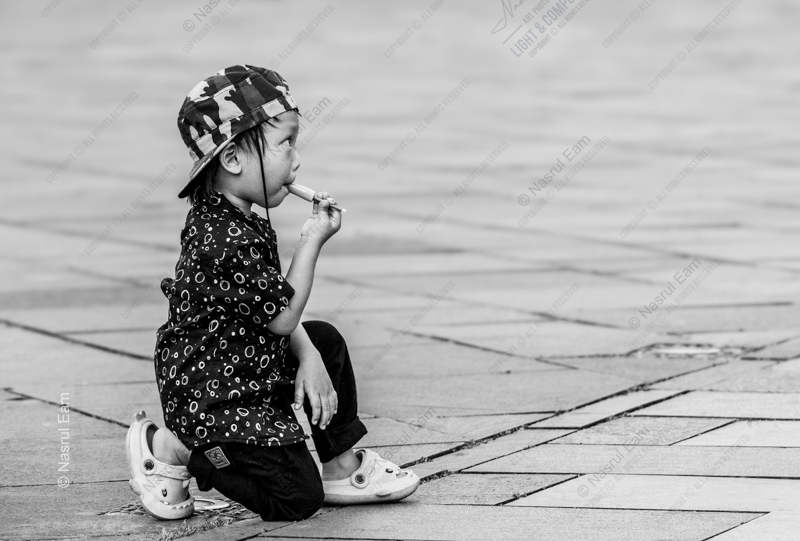 Child with an Ice Pop on the Pavement - Fine Art Photography Print, Limited Edition Photography, Black and White Photography, Documentary Photography,  Child Portrait