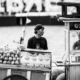 A Fruit Vendor and a Cook at their Carts