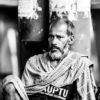 Man Resting by a Poster Wall - Fine Art Photography Print, Limited Edition Photography, Black and White Photography,  Environmental Portraiture, Art Photography Investment