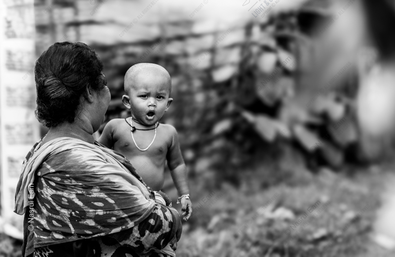 A Child's Gaze Over His Mother's Shoulder