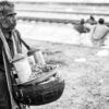 Vendor by the Railway Tracks - documentary portraiture, photography technique tutorials, visual storytelling photography, human emotion in photography, street photography guide