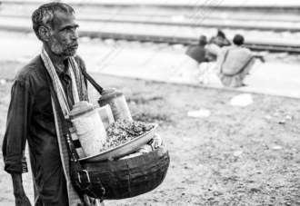 Vendor by the Railway Tracks - documentary portraiture, photography technique tutorials, visual storytelling photography, human emotion in photography, street photography guide