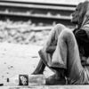 Woman Seated by the Railway Tracks - documentary portraiture, fine art photography, visual storytelling, photography books, photo technique, contemporary journals, human emotion, light and texture